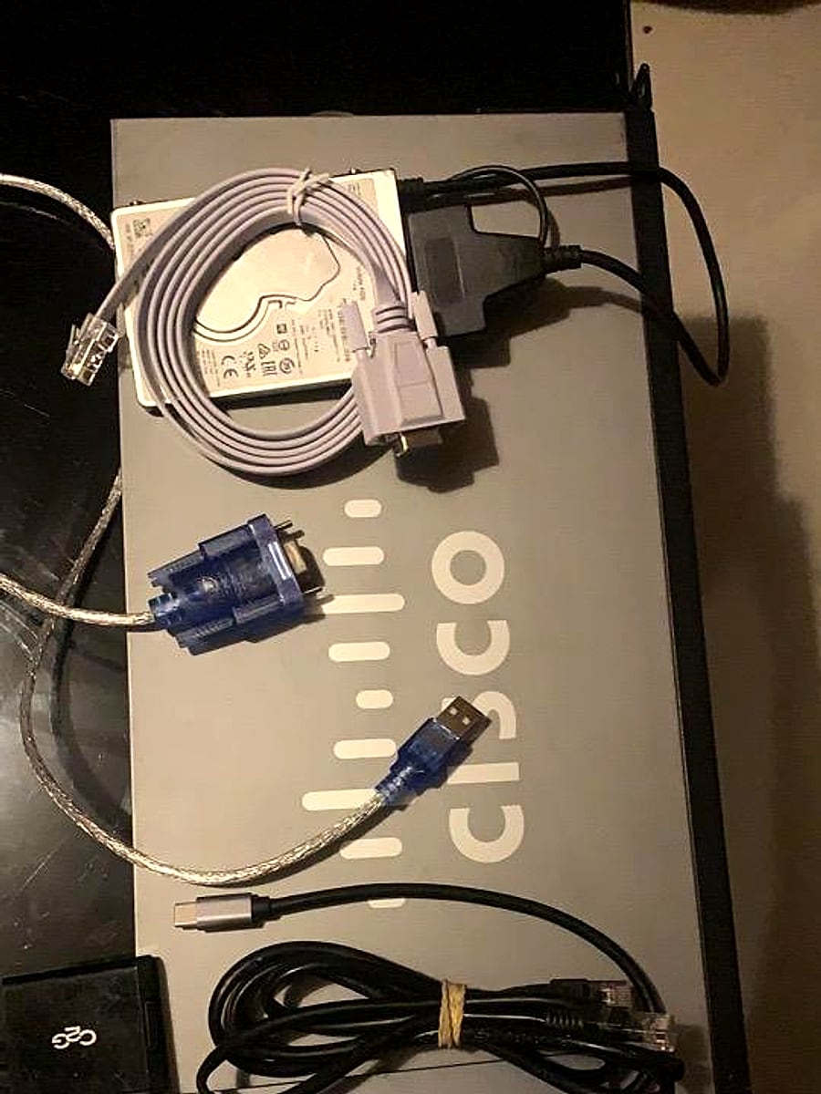 Network adapters, patch leads, and power accessories on a table.